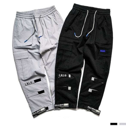 Two pairs of VantageGo Streetwear Joggers in gray and black cotton fabric with cargo pockets and drawstring waistbands