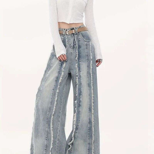 Woman wearing raw edge loose jeans with a relaxed fit and unfinished hems paired with a white cropped top