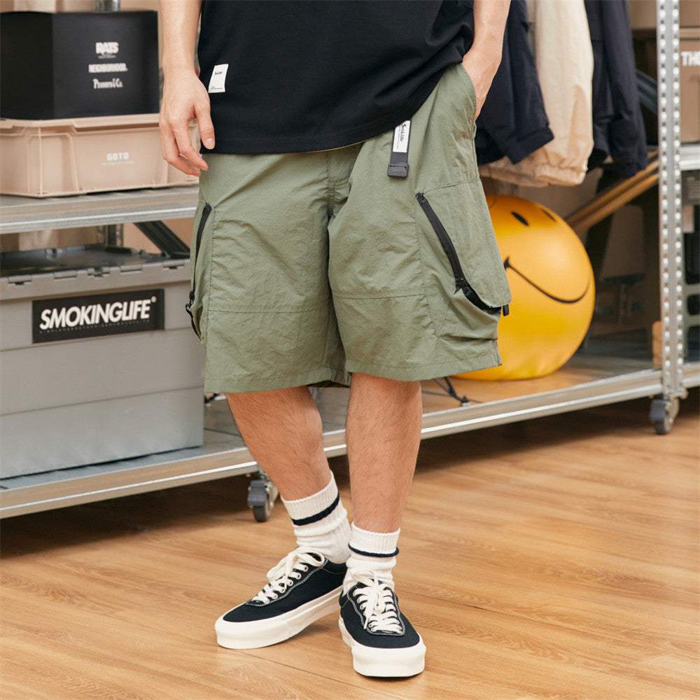 American Style Work Shorts in green nylon with multi-pocket design and straight leg style worn with black sneakers and white socks